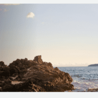 a rocky beach with waves crashing on it